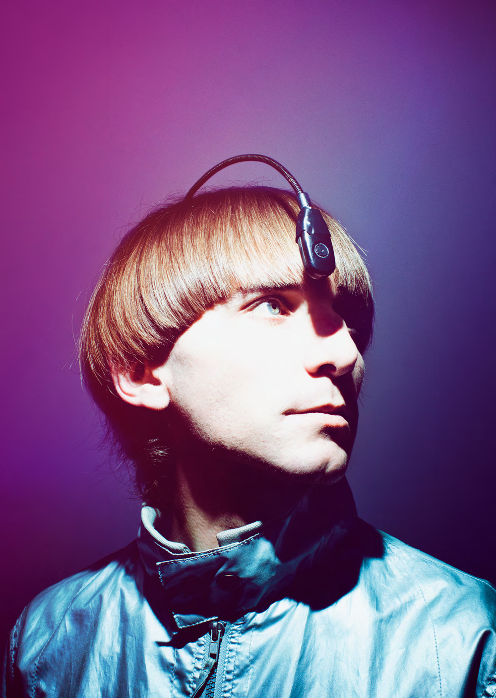 A bronze sculpture of Neil Harbisson with his eyeborg antenna. The antenna goes from inside the back of his head to hanging over his forehead.