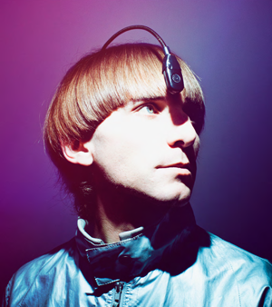 A bronze sculpture of Neil Harbisson with his eyeborg antenna. The antenna goes from inside the back of his head to hanging over his forehead.